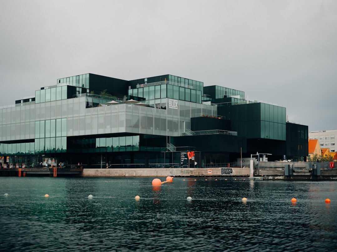 Modern glass office building exterior in a Danish city on a clear day